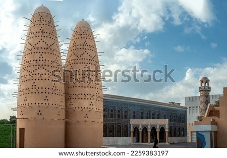 Pigeon Towers in Katara Cultural Village in Doha. Pigeon towers and blue sky near Mosque in Katara, cultural village, Valley of Cultures, West Bay, Doha, Qatar, Middle East