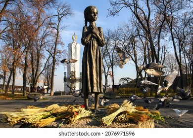 Pigeons fly near the Monument to the victims of the Holodomor (big hunger in Ukraine) who died of starvation in 1932-33. Kyiv, Ukraine, September, 2021