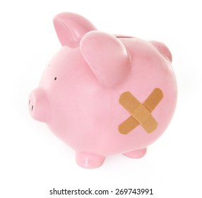 Piggy Bank With Band Aid On White Background