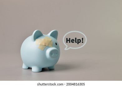 Piggy Bank And Band Aids With Text HELP. Copy Space