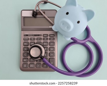 Piggy bank and calculator and health insurance. Cost of medical treatment and finances - Shutterstock ID 2257258239