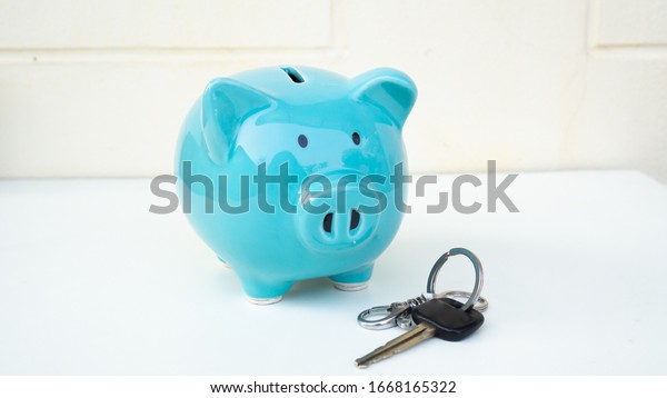 piggy\
bank and car key, saving money for new car\
concept