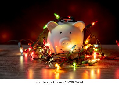 piggy bank with Christmas string lights on happy December festival, Enjoy savings for spending money on the holiday's concept.