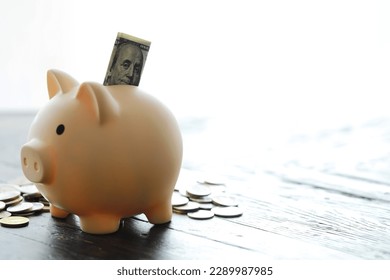 piggy bank with coin on old table - Shutterstock ID 2289987985
