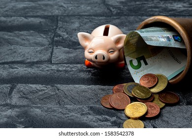 
piggy bank, coins and a banknote in a golden pot - Shutterstock ID 1583542378