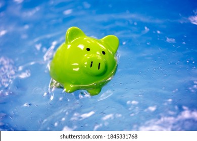 Piggy Bank Drowning In Debt Sinking In Water Concept For Bankruptcy And Business Financial Crisis