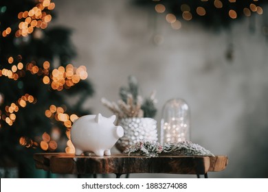 Piggy Bank In Festive New Year Atmosphere Of Scenery. Magical Bokeh With Christmas Tree And Bright Lights.