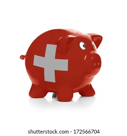 Piggy bank with flag painted over it isolated on white - Switzerland