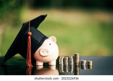 Piggy Bank With Graduation Cap On Black Glass Floor,Money Saving Concept.	