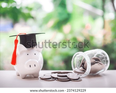 Piggy bank with graduation hat, Glass bottle and coins. The concept of saving money for education, student loan, scholarship, tuition fees in future
