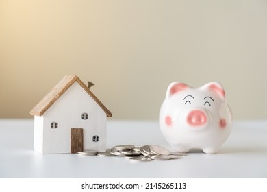 Piggy Bank And House Saving For New Living Concept. Save More Money To Buy Or Rent New House.