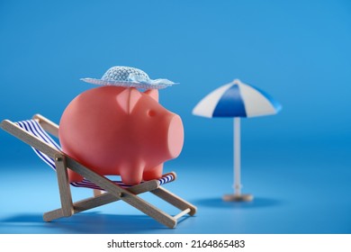 Piggy Bank On Beach Chair Against  Blue Background