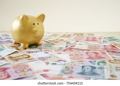 Piggy Bank On Chinese Yuan Banknotes