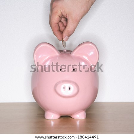 piggy bank with person dispensing coin 