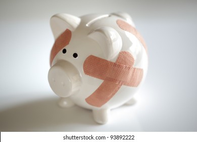 Piggy Bank With Plasters Concept For Financial Crisis Or Economic Depression