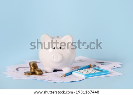 Piggy bank with savings, calculator and documents on color background. Concept of pension