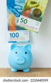 Piggy Bank And Swiss Money, 100 And 50 Francs, Concept For Saving And Banking, Vertical Photo