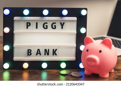 Piggy Bank Word Written On Marquee Lightbox - Savings Concept. High Quality Photo