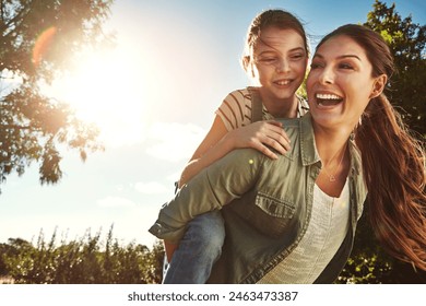 Piggyback, mom and girl with blue sky in outdoor park for game, fun and bonding together. Nature, playing and happy mother with daughter on back for support, summer vacation or weekend in Colorado - Powered by Shutterstock