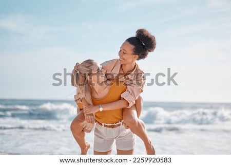 Piggyback, ocean and happy couple of friends for lgbtq, lesbian or love and freedom on summer vacation together. Blue sky, beach and diversity women on date, fun support or excited valentines holiday