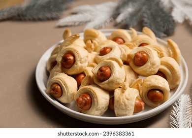 Pigs in a blanket, traditional festive Christmas food on the table. - Shutterstock ID 2396383361