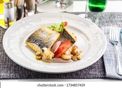 Pike perch fillet with chorizo, cauliflower and radish in a restaurant serving