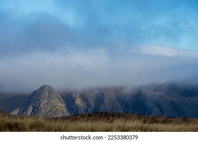 Pike of Stickle in the Great Langdale Valley in the Lake District National Park, as seen from the fells around Pike of Blisco and Crinkle Crags. Taken on a moody day with dramatic clouds.  - Shutterstock ID 2253380379