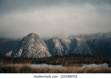 Pike of Stickle in the Great Langdale Valley in the Lake District National Park, as seen from the fells around Pike of Blisco and Crinkle Crags. Taken on a moody day with dramatic clouds.  - Shutterstock ID 2253380701