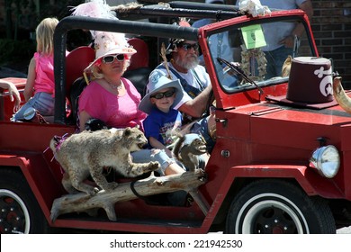 PIKEVILLE, KENTUCKY - 4/26/14 - Hillbilly Days - Family Of Hillbillies In An Open Air Car With Stuffed Bobcat And Squirrel As They Enter A Parade In Honor Of Hillbilly Days In Kentucky.