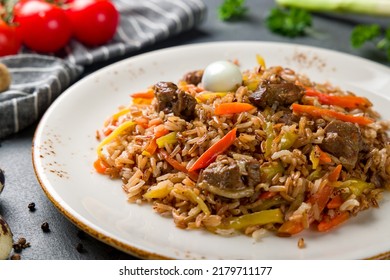 Pilaf With Beef, Eggs, Carrot On Beautiful Plate On Grey Table Macro Close Up