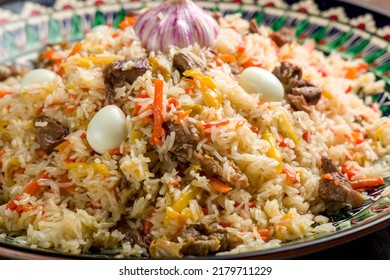 Pilaf With Beef, Eggs, Carrot On Beautiful Uzbek Plate Macro Close Up