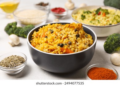 Pilaf in bowls, rice, spice and vegetables on white background, close up - Powered by Shutterstock