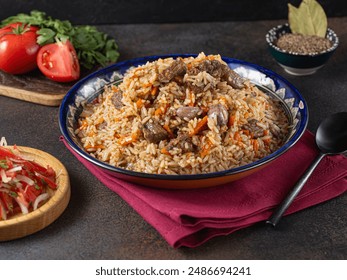 Pilaf, a dish of rice, chicken, carrots with spices and dried cranberries on a black plate on a dark wooden background. Eastern cuisine. - Powered by Shutterstock