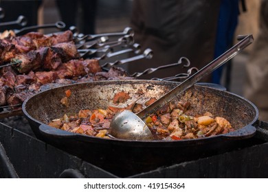 Pilaf In A Old Cauldron And Ladle, Barbecue.