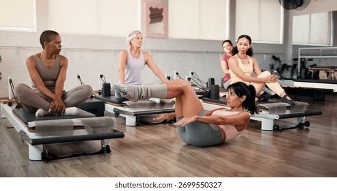 Pilates, class or instructor with demonstration in studio for reformer technique, guidance or lesson. Fitness club, women or coach with instructions on machine form, body alignment or teaching skills