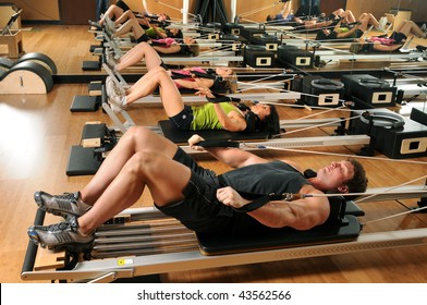 Pilates Class With Men And Women At A Gym