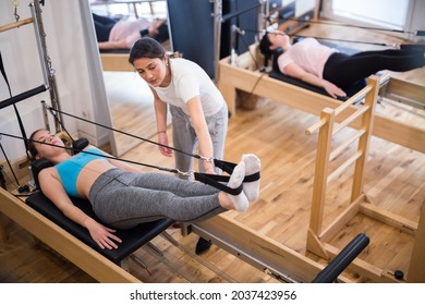 Pilates Instructor Training Women At The Gym