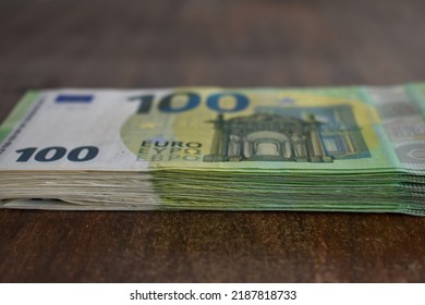 Pile Of 100 Euro Bank Notes On A Table