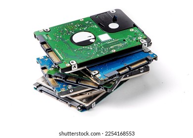 A pile of 2.5 inch internal notebook computer SATA hard disk drives isolated on white
