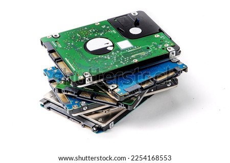A pile of 2.5 inch internal notebook computer SATA hard disk drives isolated on white