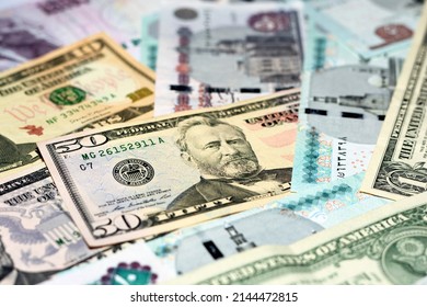 Pile of 5, 10, 20 and 50 LE five, ten, twenty and fifty Egyptian pounds money banknotes and 1, 5, 10 and 50 $ one, five, ten and fifty American dollars bills, American and Egyptian money exchange rate