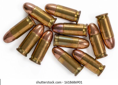 Pile of 9mm bullets on a white background. Image