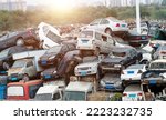 A pile of abandoned cars on junkyard.