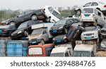 A pile of abandoned cars on junkyard.