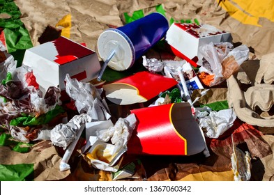 A Pile Of Abandoned Garbage On The Street, Including Food Waste, Cans Of Cola, Beverage, Fast Food Packaging, Close-up, Can Be Used As A Background Or Texture