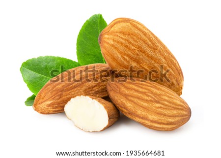 Pile of almond nuts and almond slice with green leaf isolated on white background.