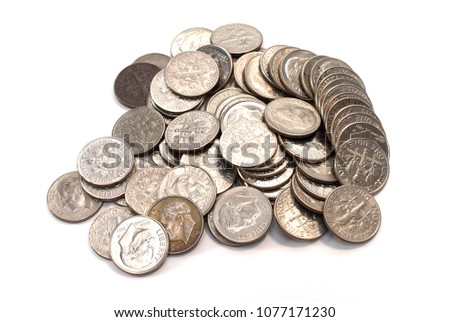 Pile of American coins (dime) on a white background.