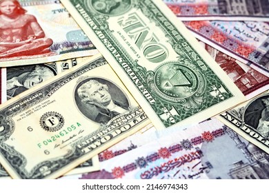 A pile of American dollars and Egyptian pounds background, a stack of 50 LE fifty pounds, 200 LE two hundred pounds, 1 $ one dollar and 2 $ two dollars, American and Egyptian money exchange rate