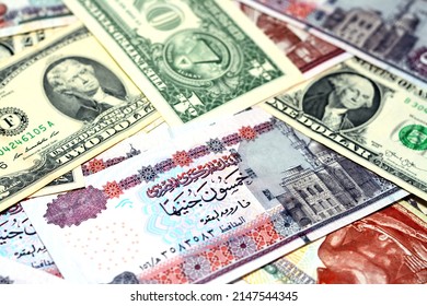 A pile of American dollars and Egyptian pounds background, a stack of 50 LE fifty pounds, 200 LE two hundred pounds, 1 $ one dollar and 2 $ two dollars, American and Egyptian money exchange rate