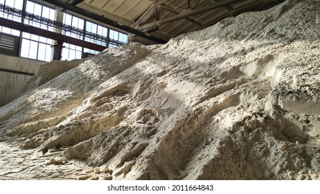 Pile Of Ammonium Sulfate Powder Inside A Warehouse Of Chemical Plant. Mineral Organic Fertilizers For Agriculture Industry.